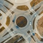 Top view of a roundabout with cars entering and exiting